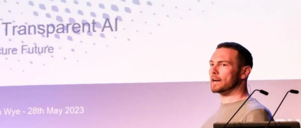 Image of a man talking to a conference delegation