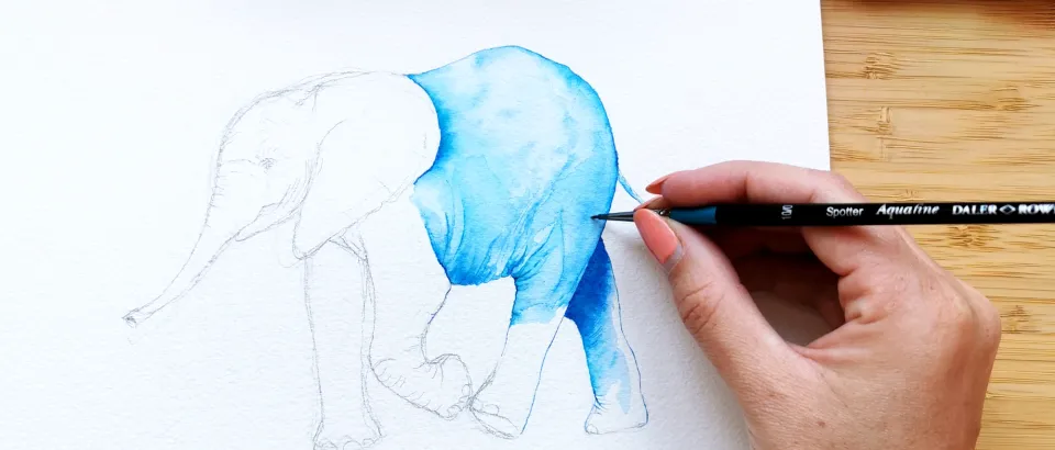 person painting an elephant