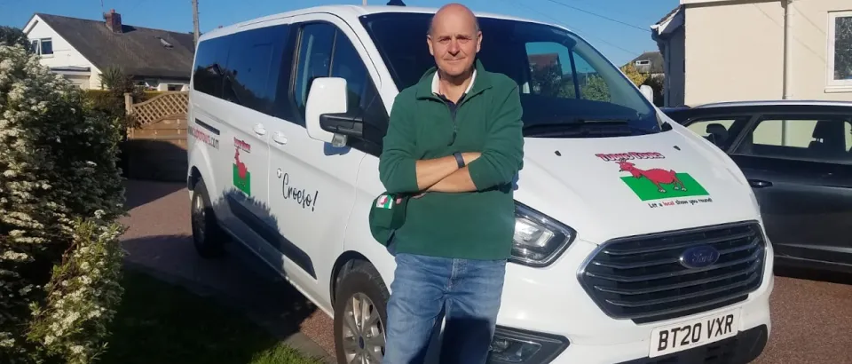 Trevor taylor standing in front of mini bus