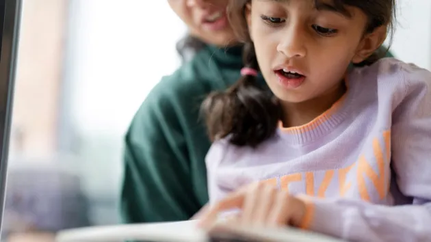 young girl reading a book