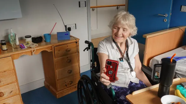 Ally John, a resident at Parklands Care Home, video calls with her son and his dog.