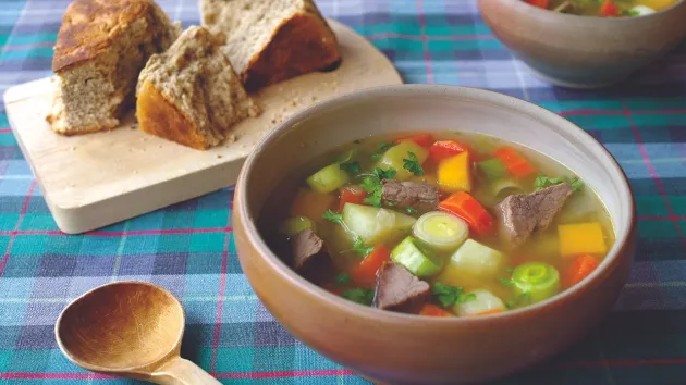 Bowl of Cawl, spoon and bread 