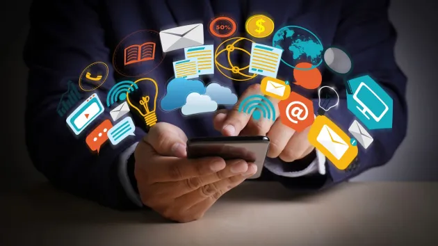 Digital symbols- person using a phone for social media 