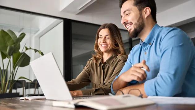 Entrepreneurs looking at a laptop