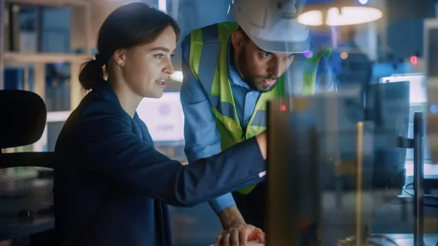 Female engineer looking at a lap top 