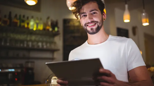 person looking at an electronic tablet