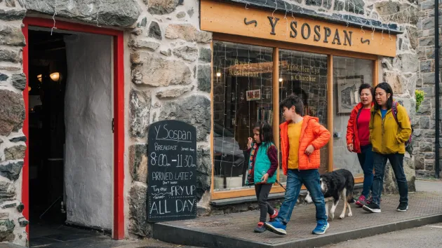 Visitors in Dolgellau outside a shop 