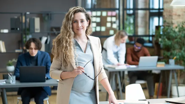 Pregnant employee working in an office 