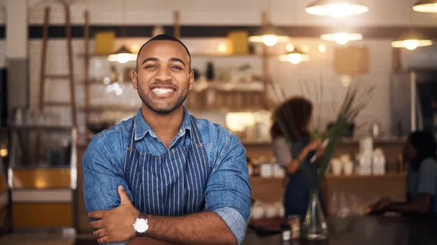 Restaurant - owner wearing a blue apron