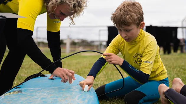 Porthcawl surf school, child on a surfboard