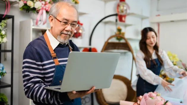 Florist looking at a digital device 
