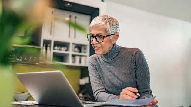 mature business woman looking at a laptop