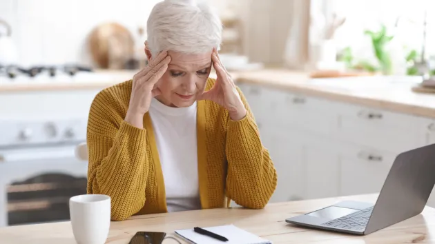 senior person trying to use a laptop 