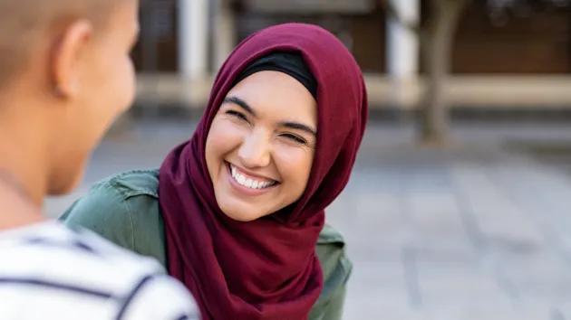 woman wearing a headscarf in conversation 