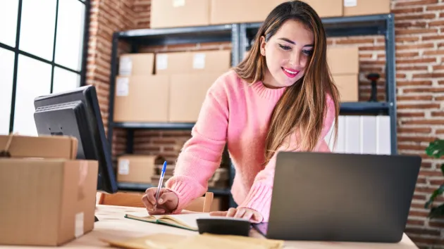 Business owner looking at a lap top.