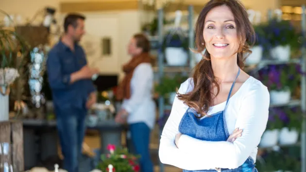 Female business owner stood outside a shop