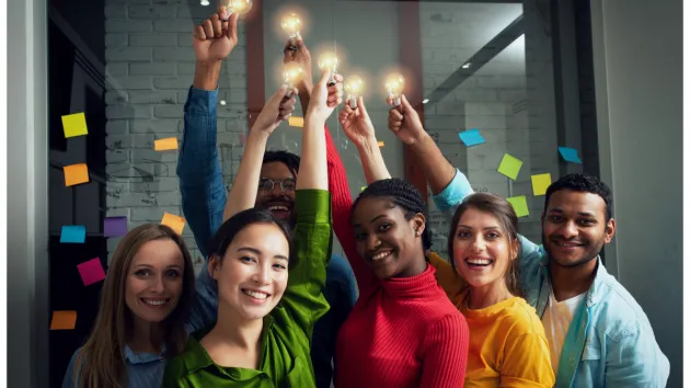 Group of people holding lightbulbs