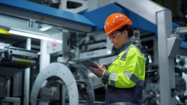 female engineer holding a digital device 