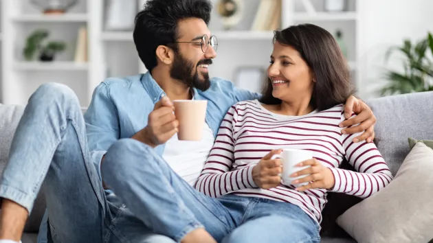 happy couple smiling sitting on the sofa