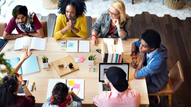 colleagues around a table - team learning 