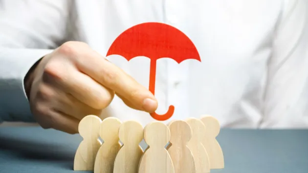 Business protection - umbrella held over people 