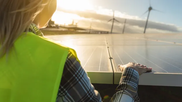 female engineer checking solar panels 
