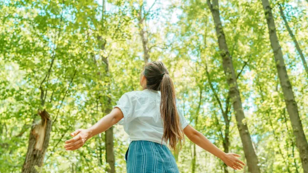 person stood in a field breathing in fresh air 