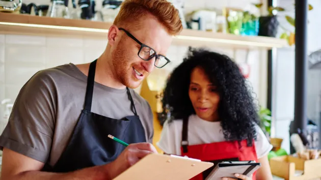 male and female colleagues working, concept of employee ownership