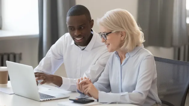 businessman and businesswoman accountants working together on pc