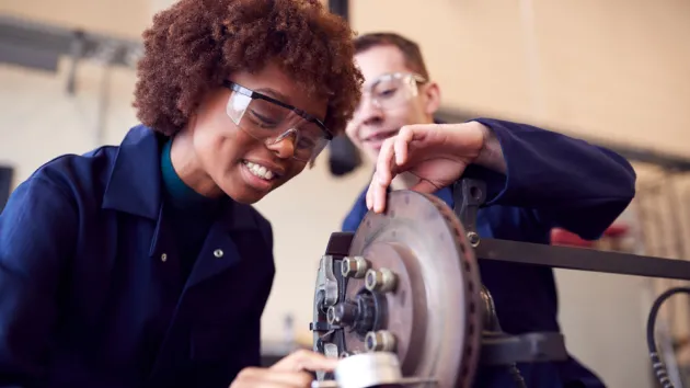 Apprentices working in a garage 