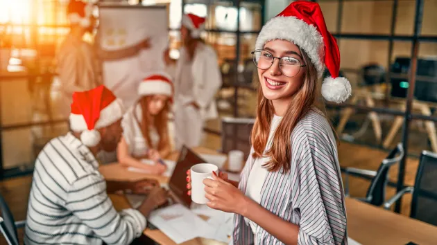 Office staff wearing Christmas hats