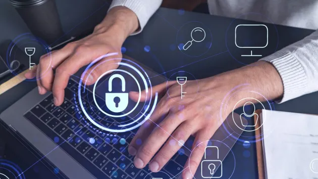 A programmer is typing a code on a keyboard to protect a cyber security from hacker attacks and save clients confidential data. 