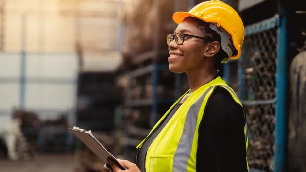 Female engineer worker enjoy working in factory industry.