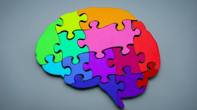 Neurodiversity - brain made up of different coloured jigsaw pieces 