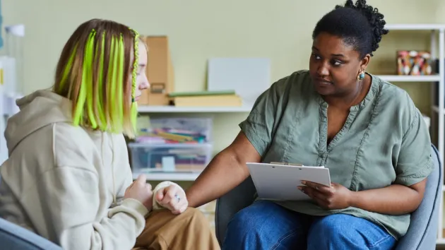 female supporting sad teenage girl during her difficult situation at school