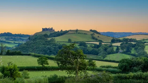 Carreg Cennen castle sitting high on a hill near the River Cennen