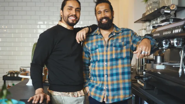 small business owners standing in their cafe 