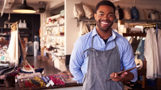 shop owner holding a digital device 