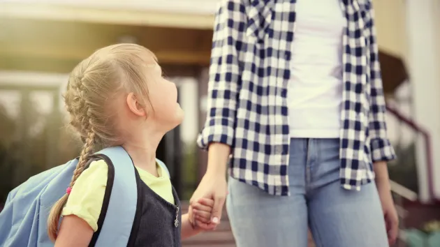 Mother taking daughter to school