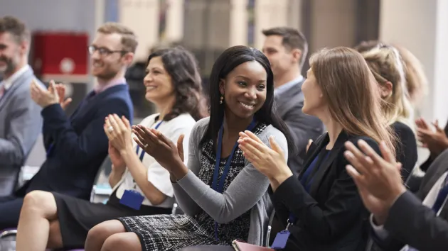 Audience Applauding Speaker After Conference Presentation