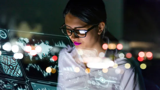 businesswoman looking at futuristic interface screen.