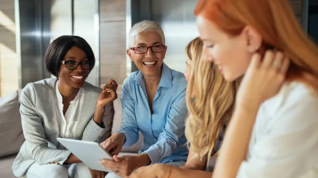 Happy business woman working together online on a tablet.