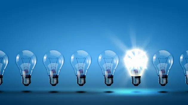row of light bulbs with one different from the others