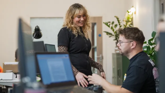colleagues discussing over laptop