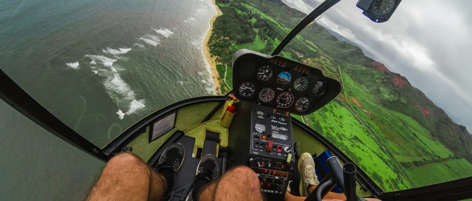 People in helicopter flying over the sea 