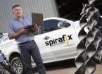 Spirafix employee stood by branded car and machinery