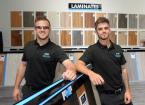 Picture of 2 men with samples of laminate flooring