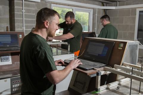 Celtest employees working in a workshop.