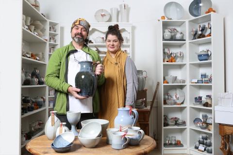Couple stand in Pottery shop