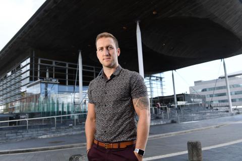 Man stood in front of Welsh Assembly 